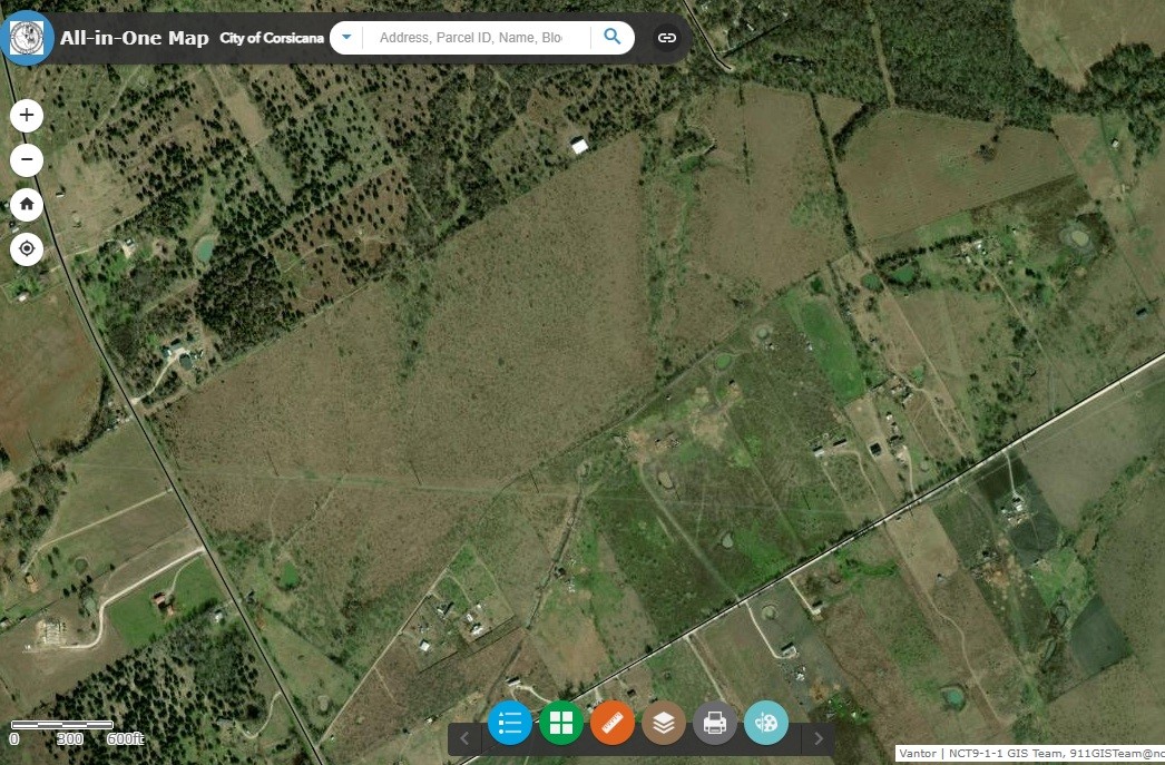 Aerial view of rural land near Corsicana, with open fields, scattered buildings, and mapped boundaries.