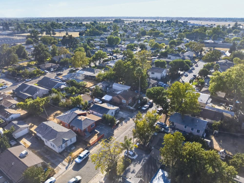 Aerial view of a residential neighborhood with tree-lined streets and homes.