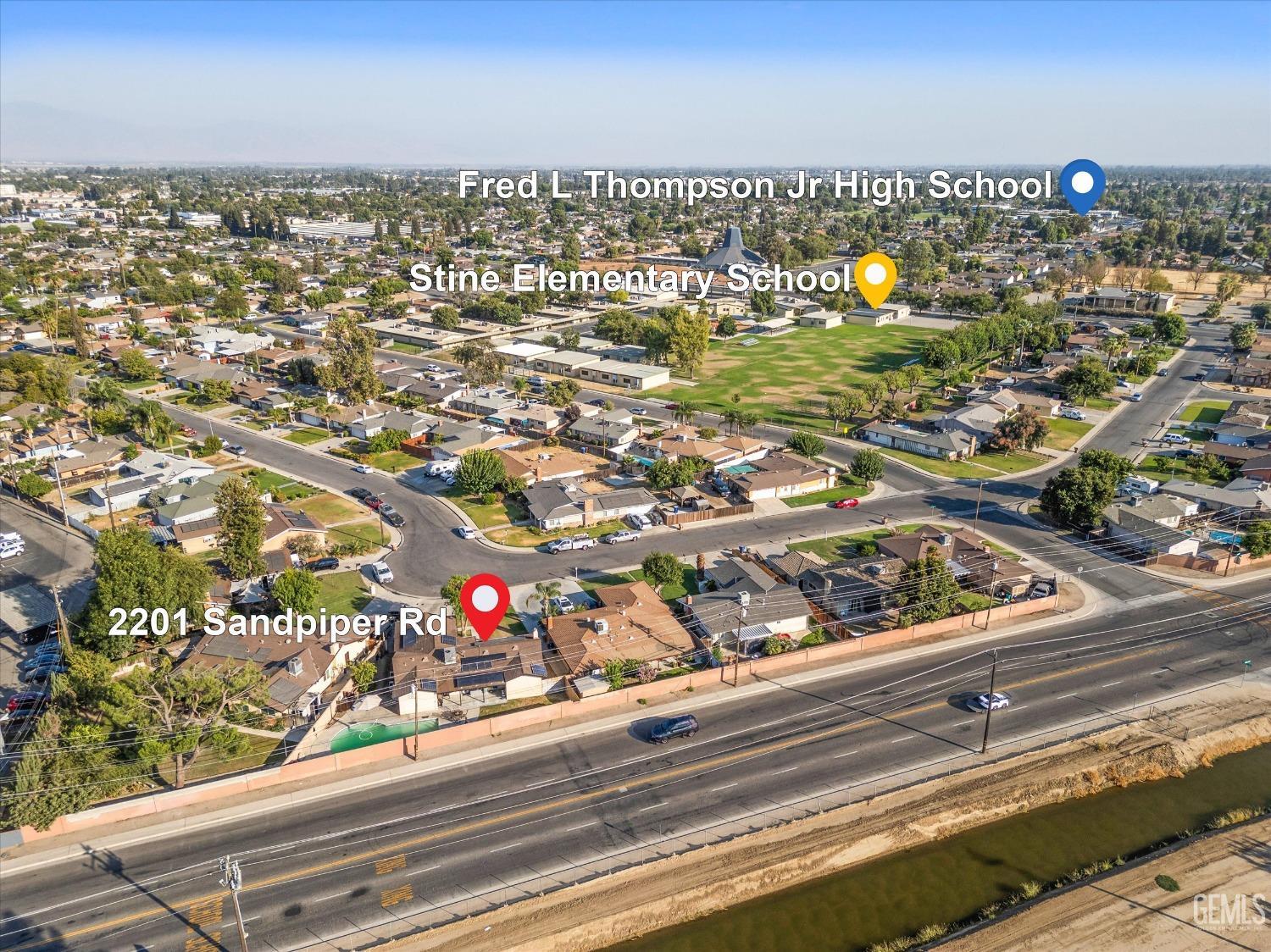 Aerial view of 2201 Sandpiper Road with nearby schools, homes, and a major road.