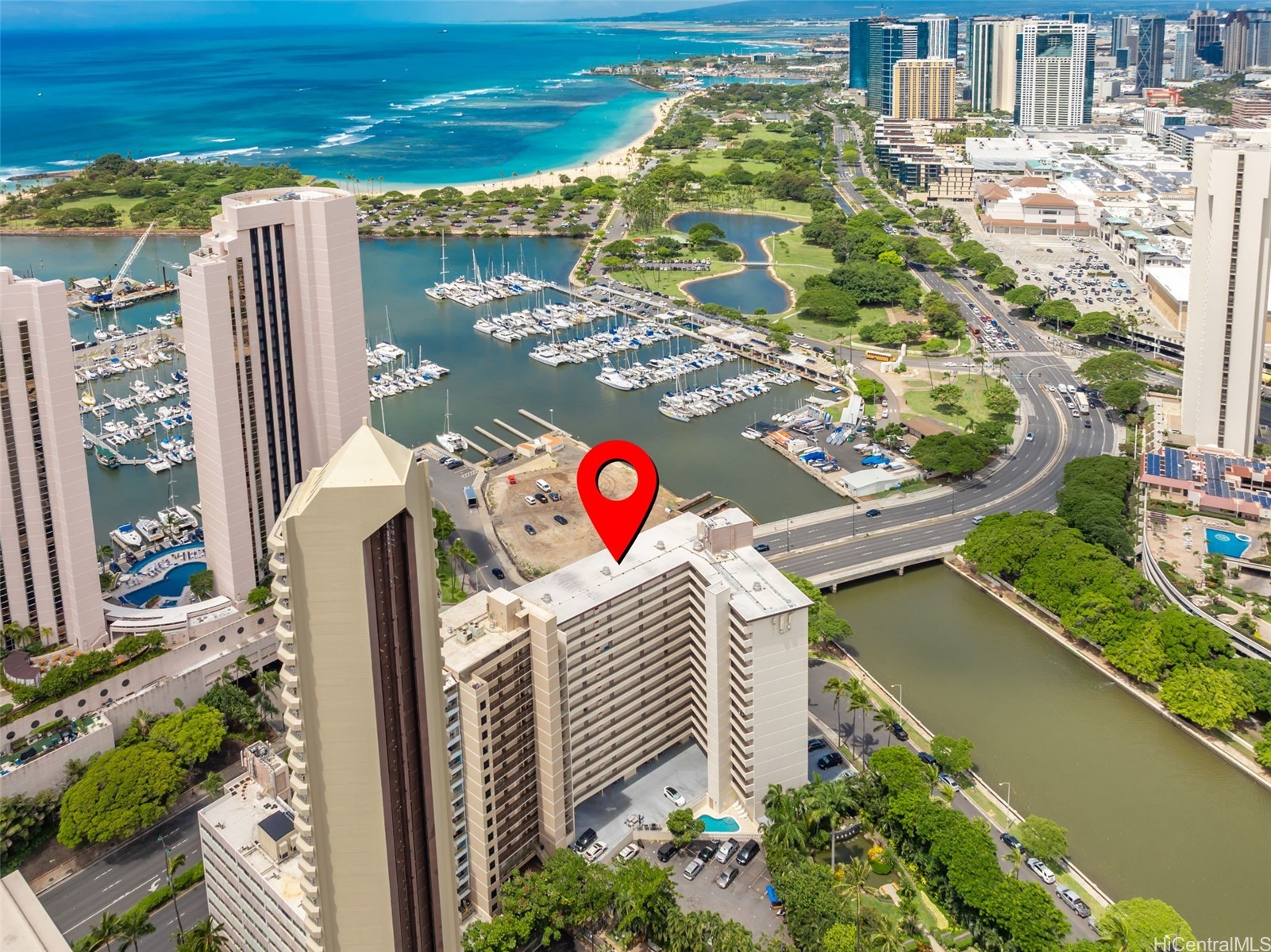 Honolulu high-rise marked by a red pin beside the marina, harbor, and ocean.