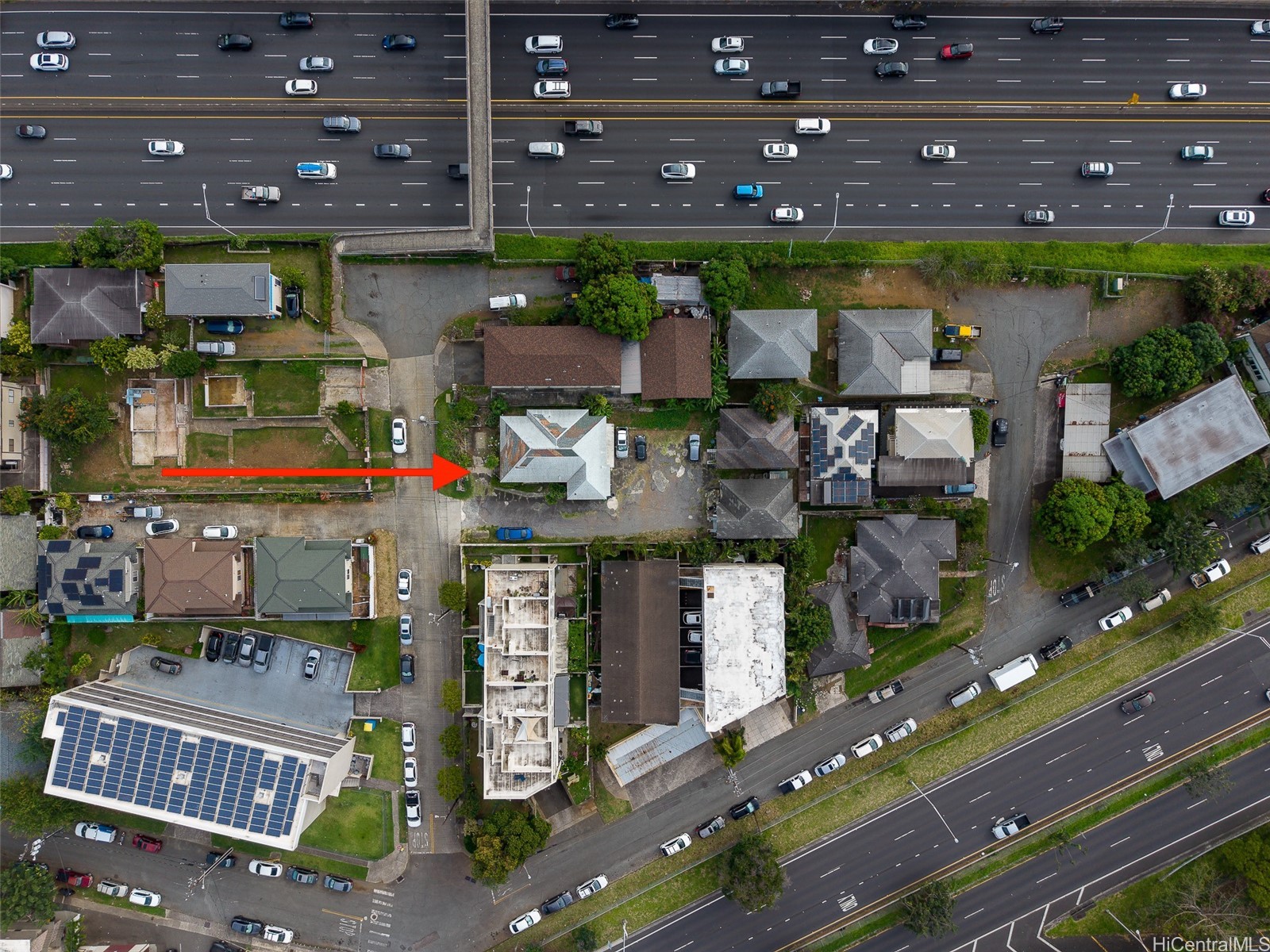 Aerial view of 1517 Miller Street, marked by a red arrow beside a multilane highway.