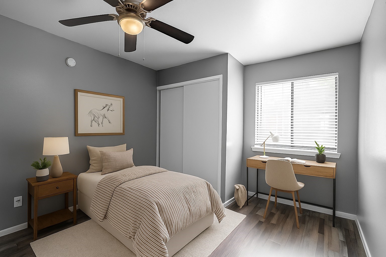 Furnished bedroom with striped bedding, a ceiling fan, and a desk beside a bright window.