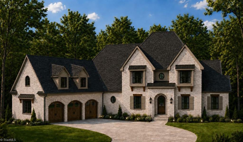 Brick home with multiple gables, three garage doors, and a curved driveway.