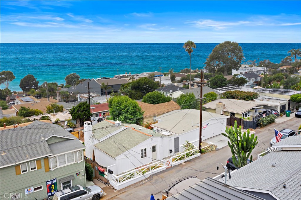 Aerial view of coastal homes overlooking the blue ocean.