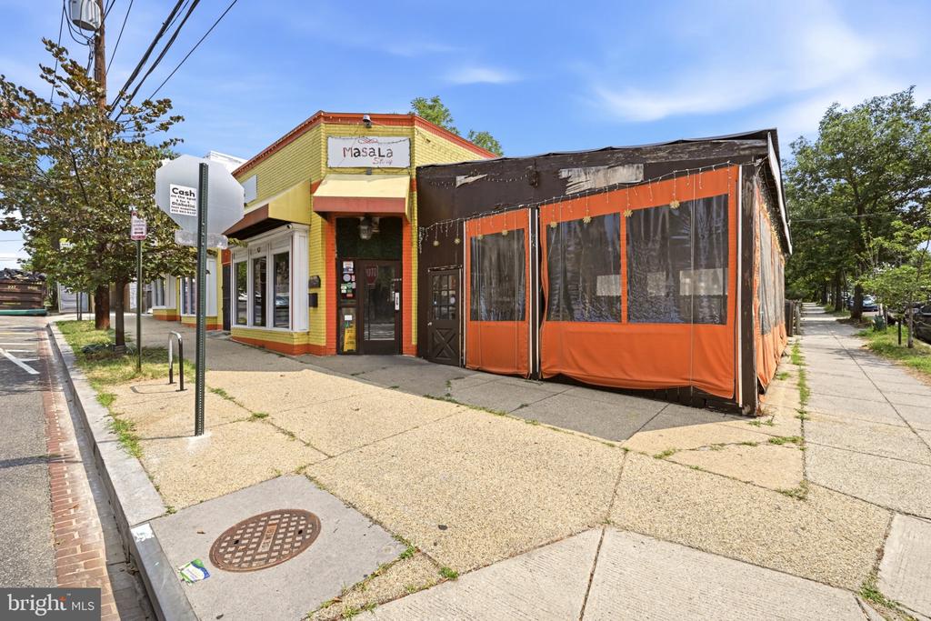 Yellow-and-red storefront with a Masala sign and an orange sidewalk patio.