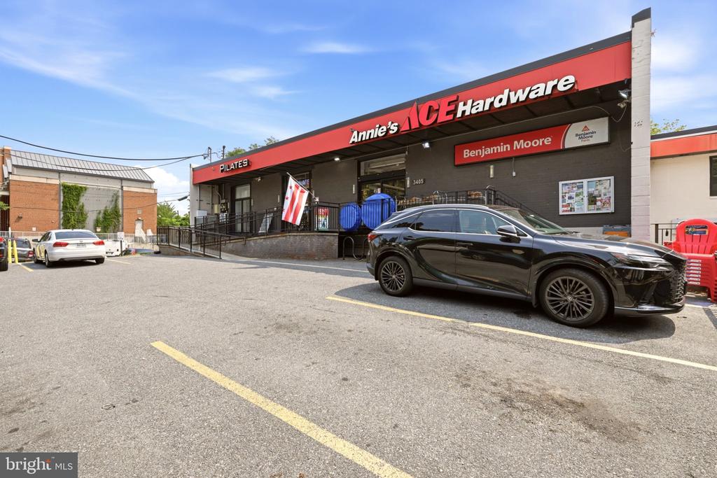 Retail storefront with Annie’s ACE Hardware and Benjamin Moore signs, viewed from the parking lot.