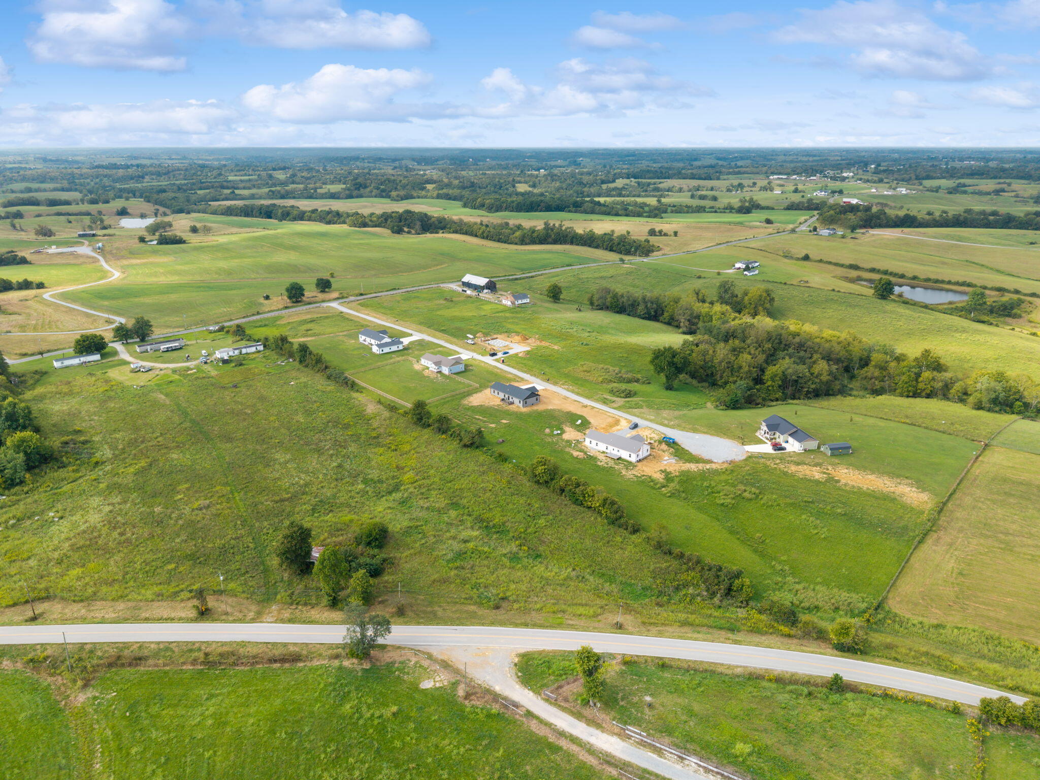Aerial view of green rural fields, scattered homes, ponds, and roads near Flemingsburg.