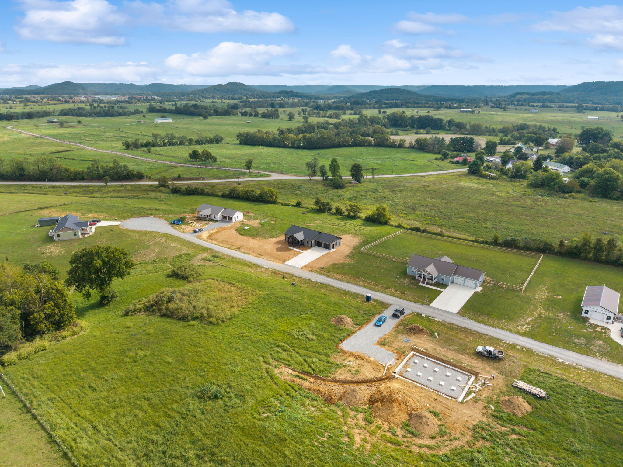 Aerial view of 150 Sunflower Road amid rural fields, nearby homes, and construction.