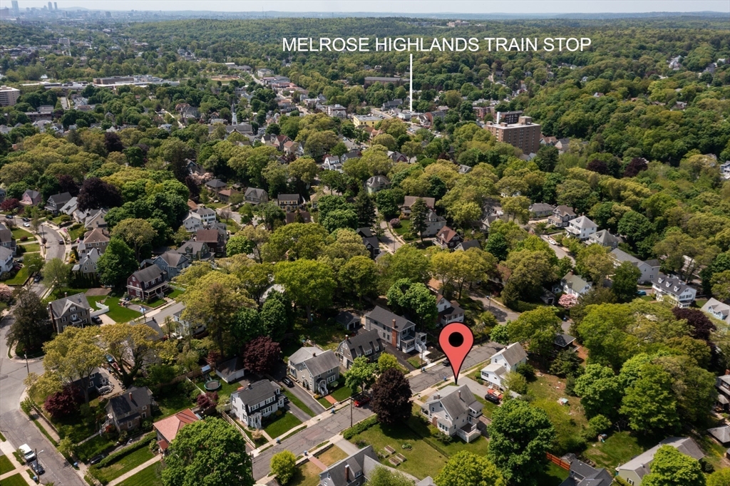 Aerial view of a leafy neighborhood, with the property marked near Melrose Highlands train stop.