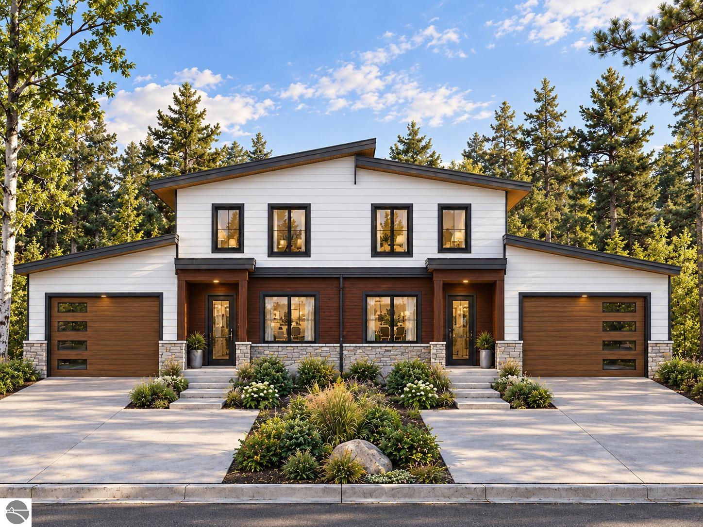 Modern two-story house with white siding, wood accents, two garages, and landscaped gardens.