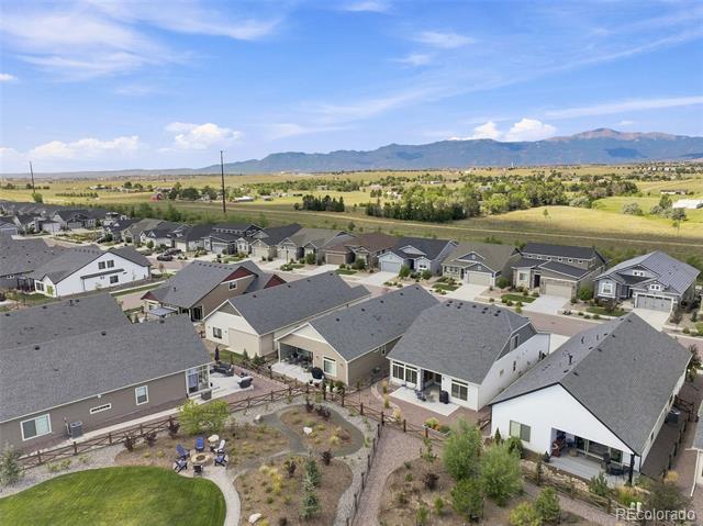 Aerial view of homes in a Colorado neighborhood with mountains in the distance.
