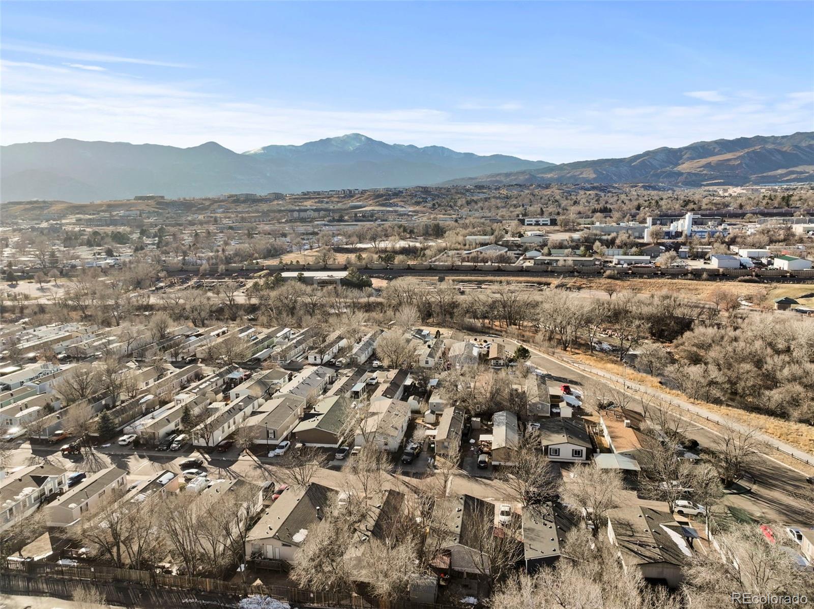Aerial view of a residential neighborhood with mountains in the distance.