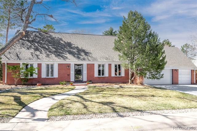Red brick single-story home with white trim, attached garage, and a curved front walkway.