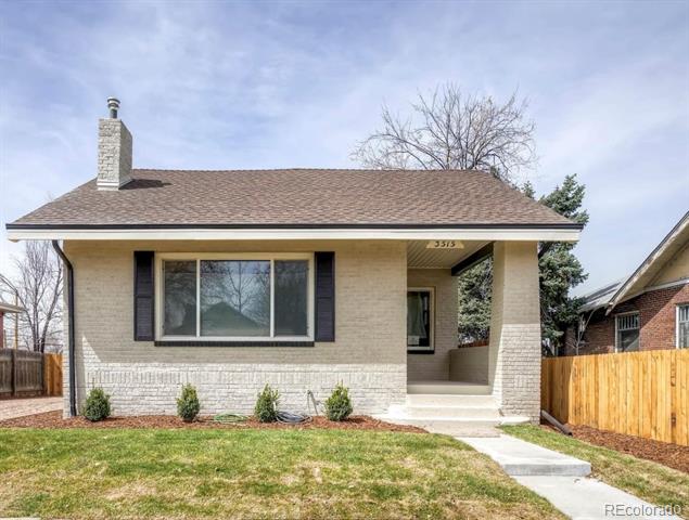 Single-story brick house with a covered entry, chimney, front lawn, and fenced yard.