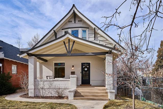Front exterior of a gabled house with a covered porch and the number 351.