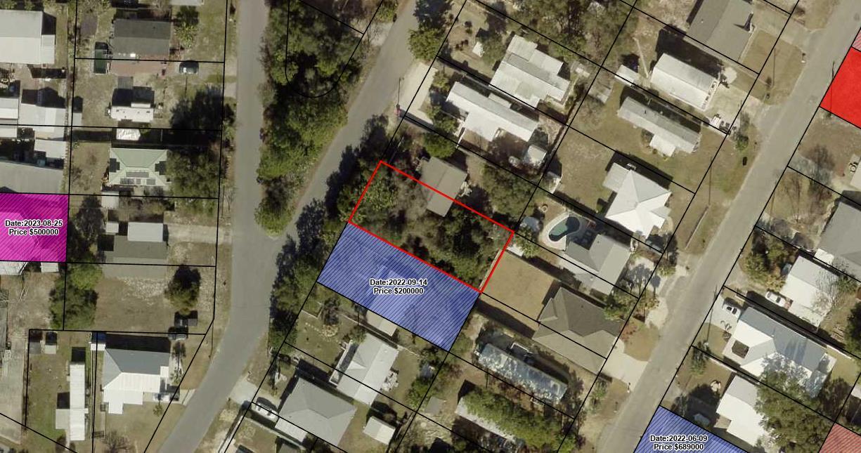 Aerial parcel map highlighting a lot outlined in red among nearby homes and properties.