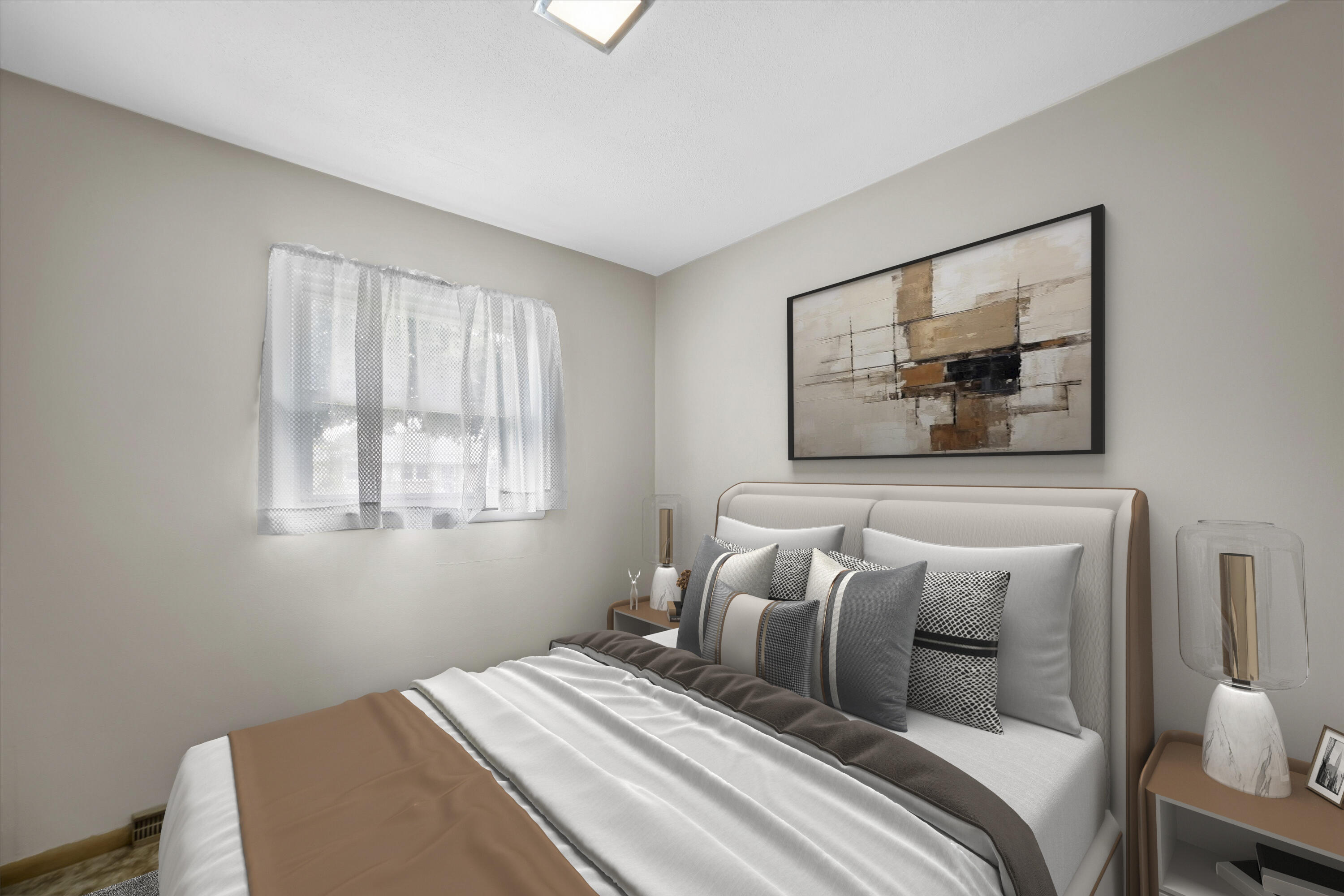 Bedroom with a white upholstered bed, layered accent pillows, and abstract artwork above the headboard.