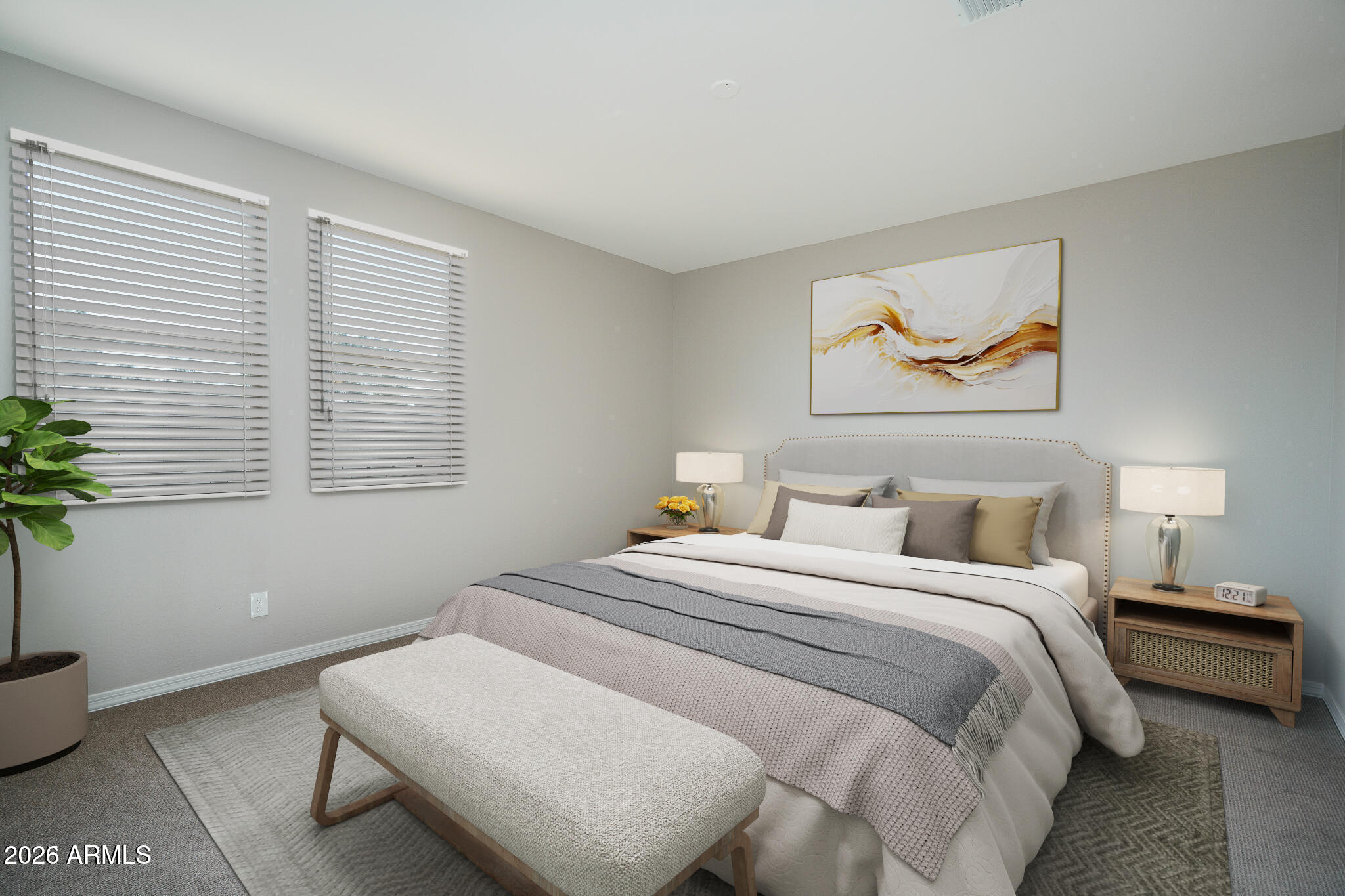 Staged bedroom with layered neutral bedding, a bench at the foot of the bed, and abstract wall art.