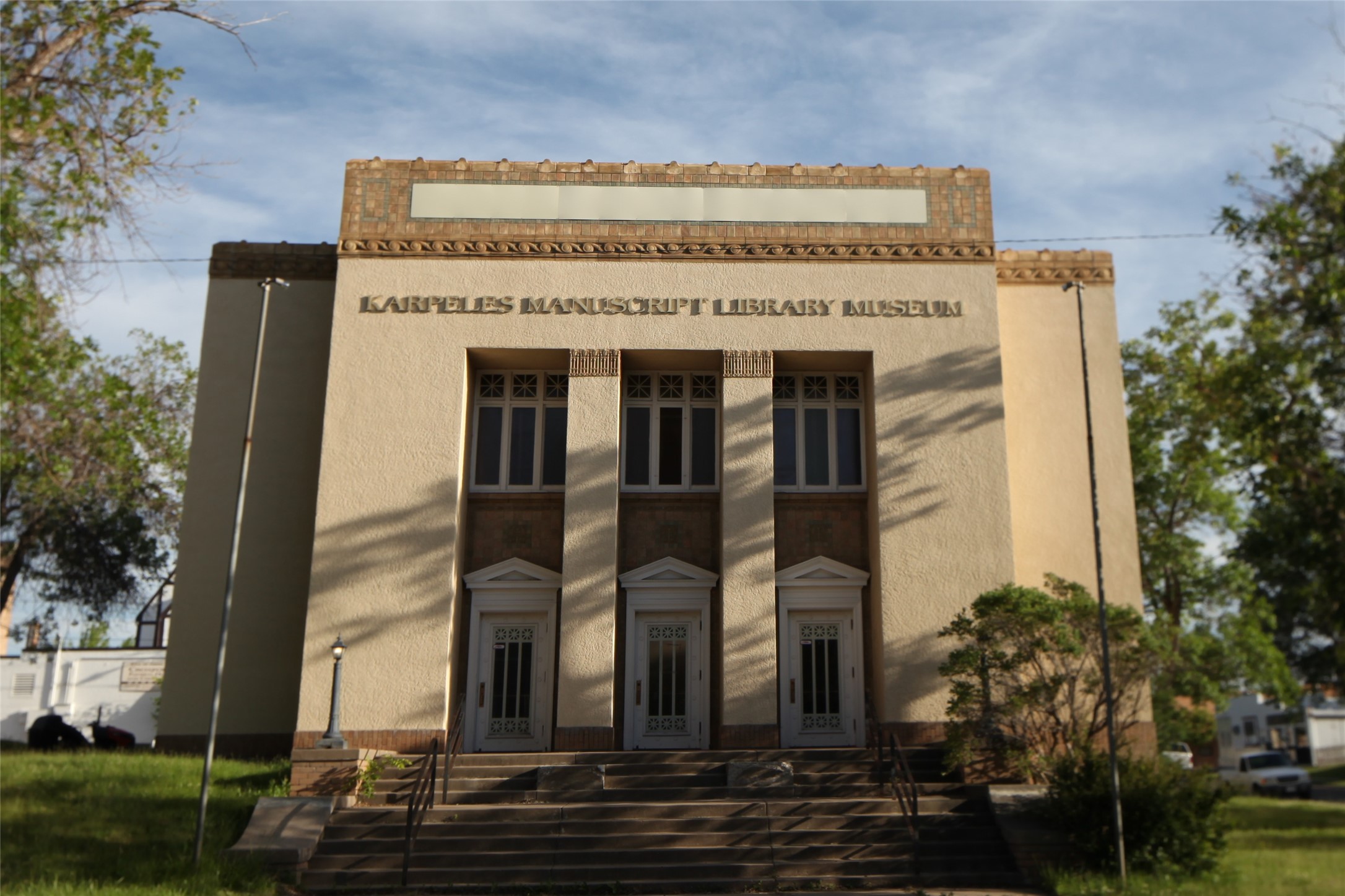 Karples Manuscript Library Museum exterior with three front doors and broad steps.