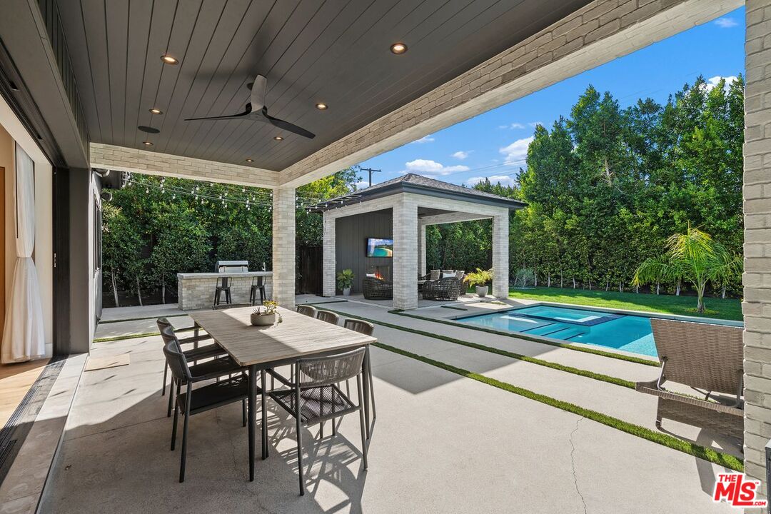 Covered patio with outdoor dining, a pavilion seating area, and a swimming pool.