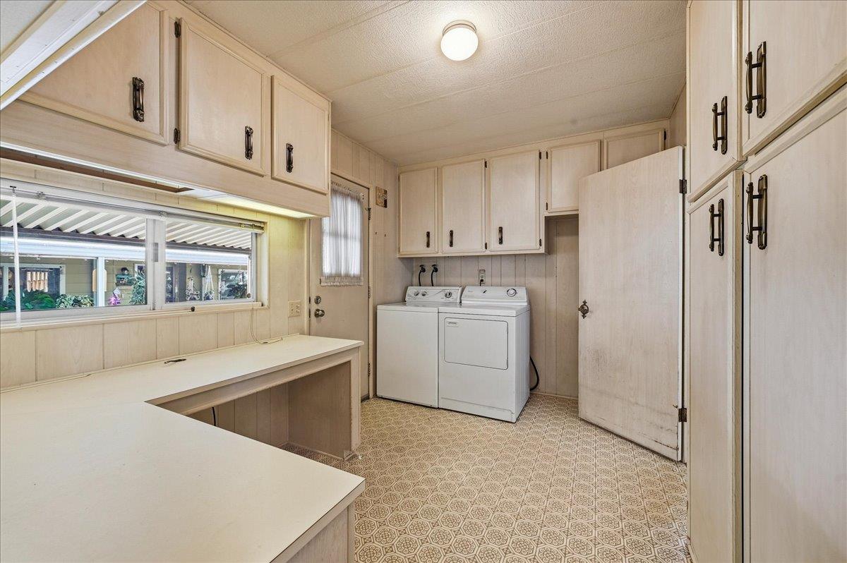 Laundry room with washer and dryer, built-in cabinets, and a long folding counter.
