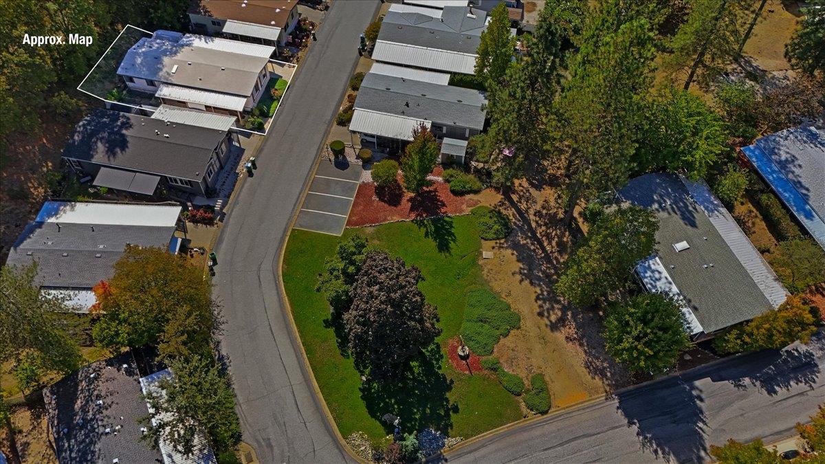 Aerial view of homes with one property outlined in white.