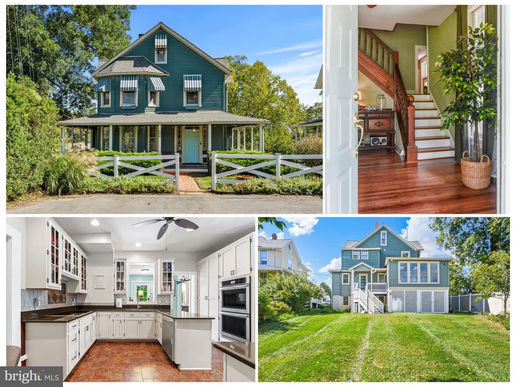 Teal two-story home with wraparound porch, white kitchen, wood staircase, and spacious lawn.