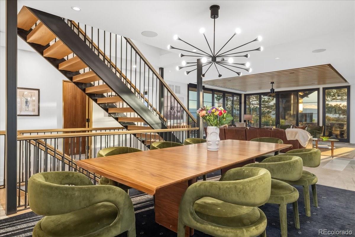 Dining room with sputnik chandelier and floating staircase