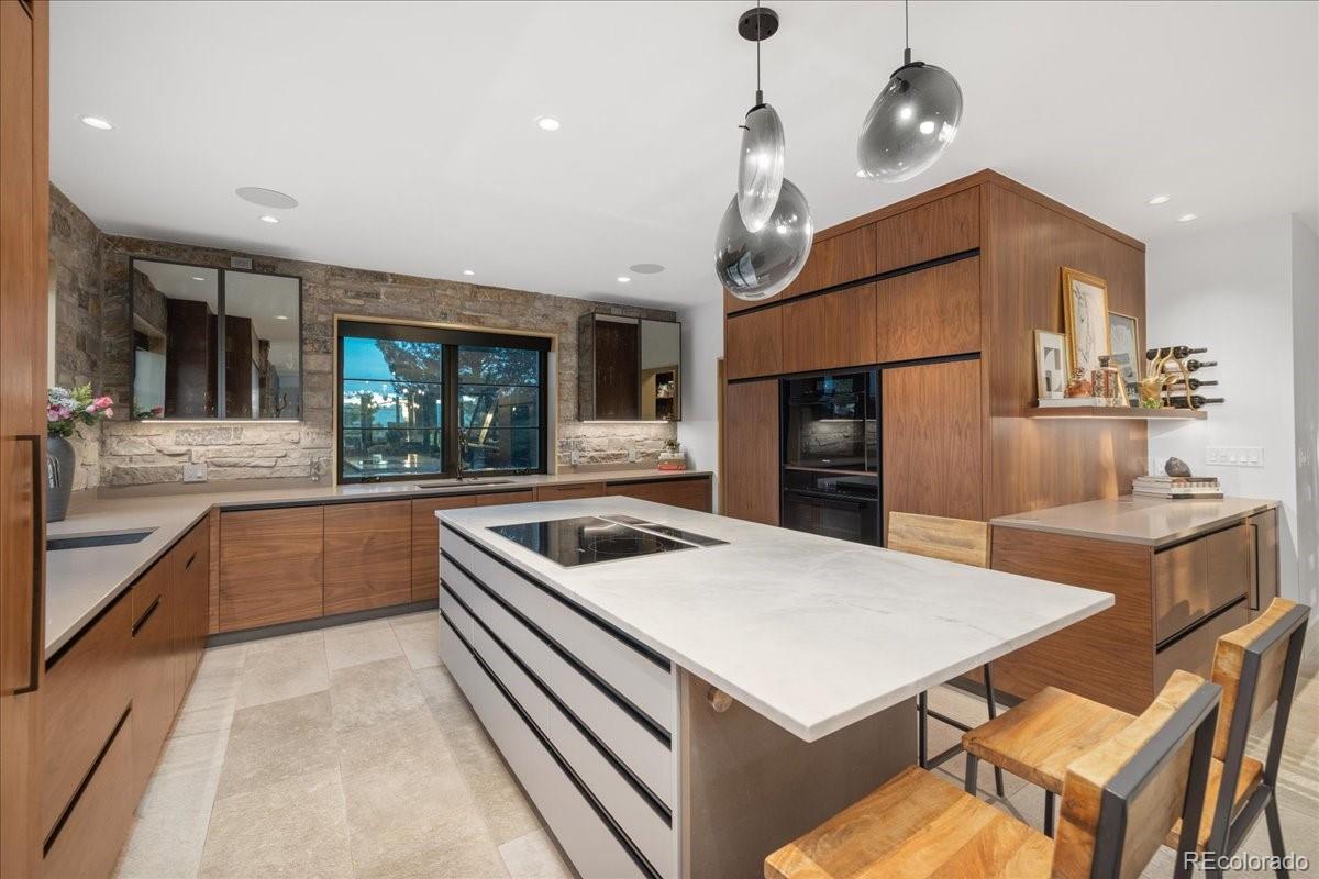 Kitchen island with pendant lighting and custom cabinetry