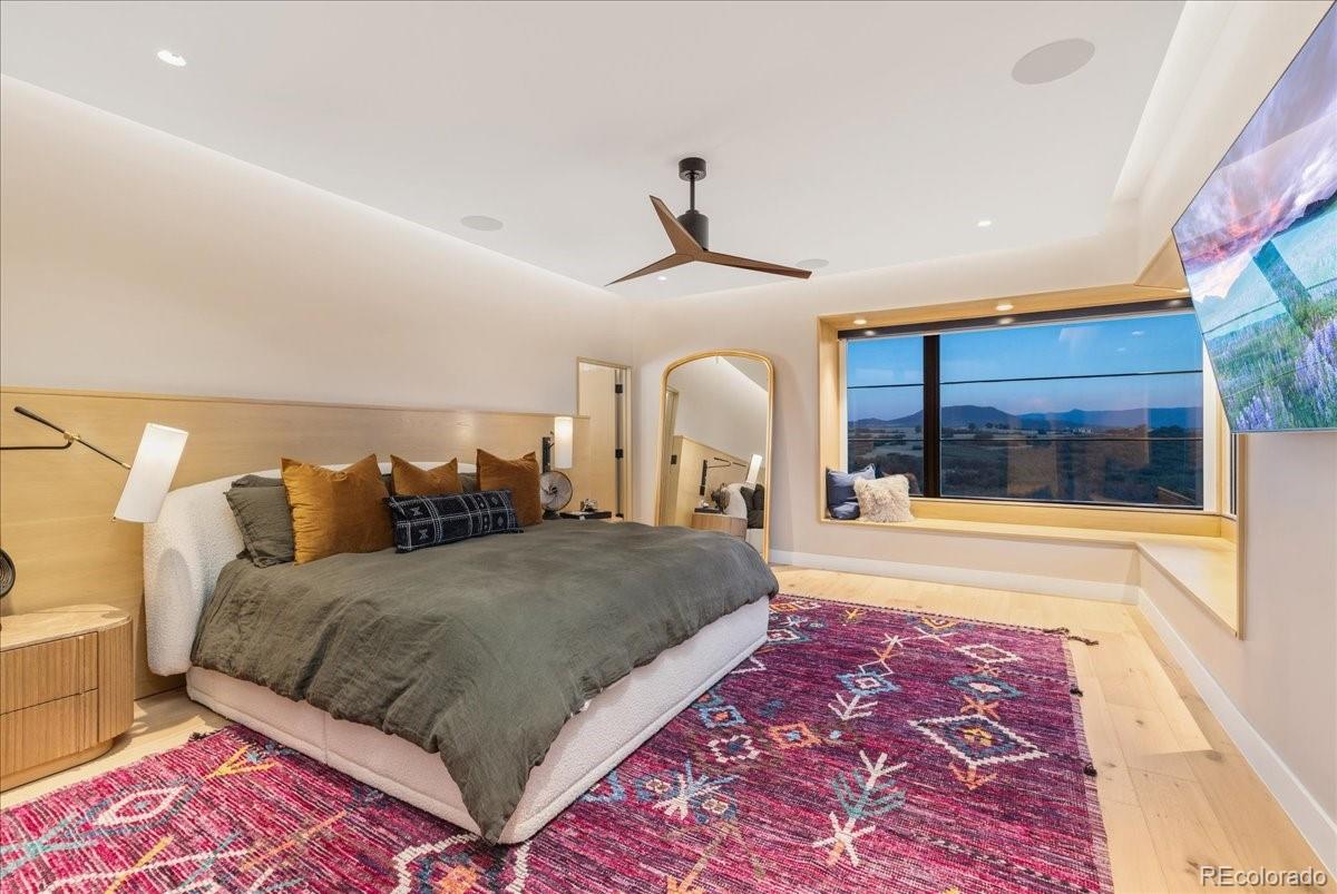 Bedroom with panoramic mountain views and ceiling fan