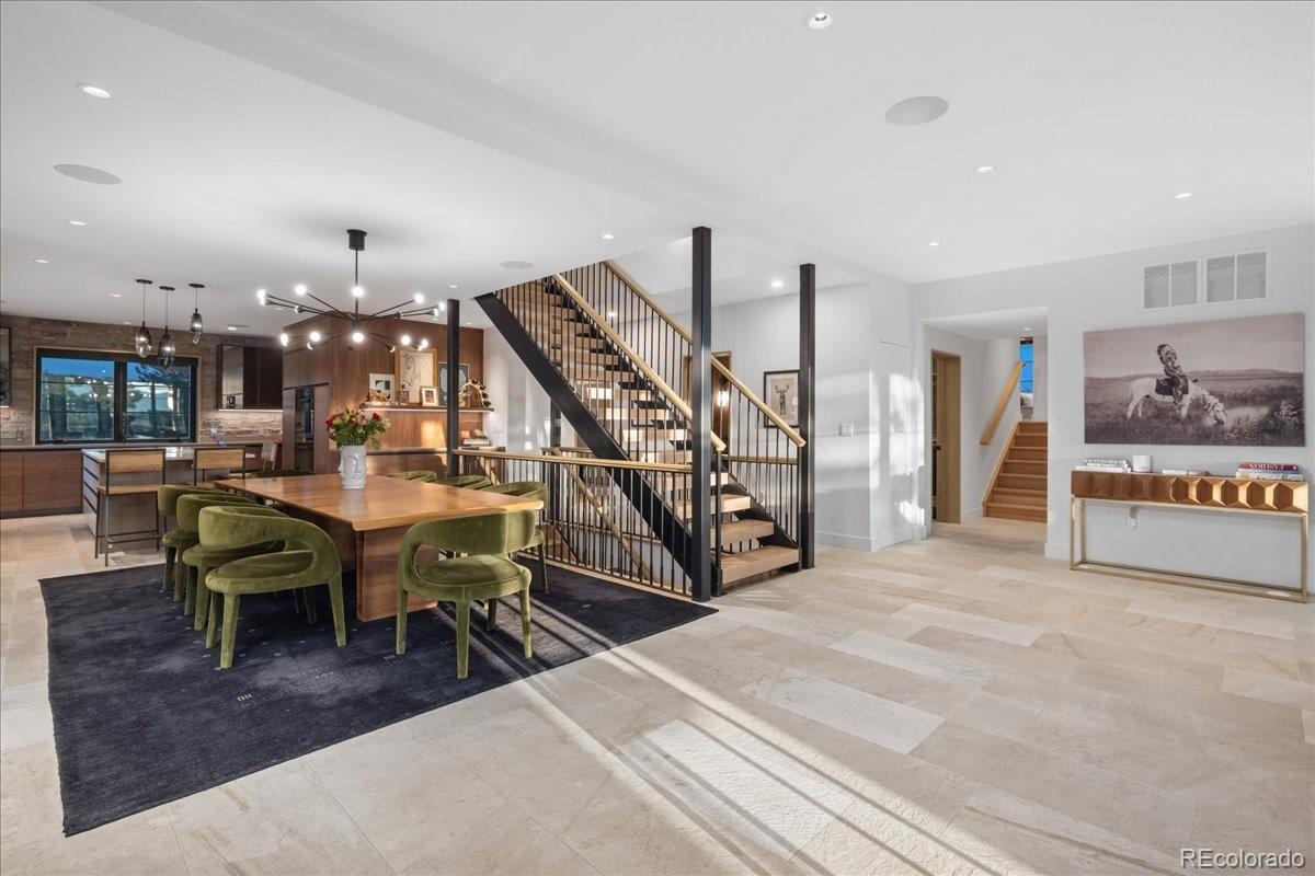 Dining area with floating staircase, Castle Rock mountain modern home