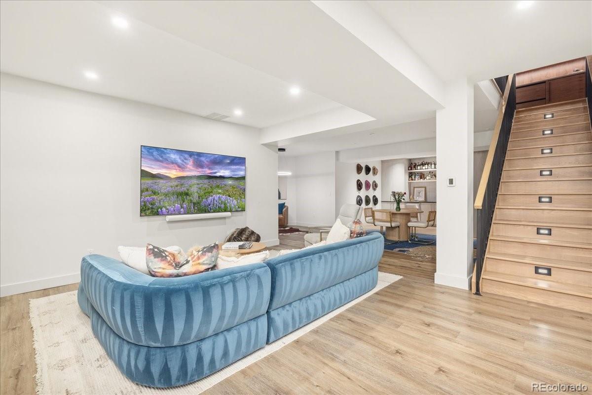 Lower-level lounge with blue sectional sofa