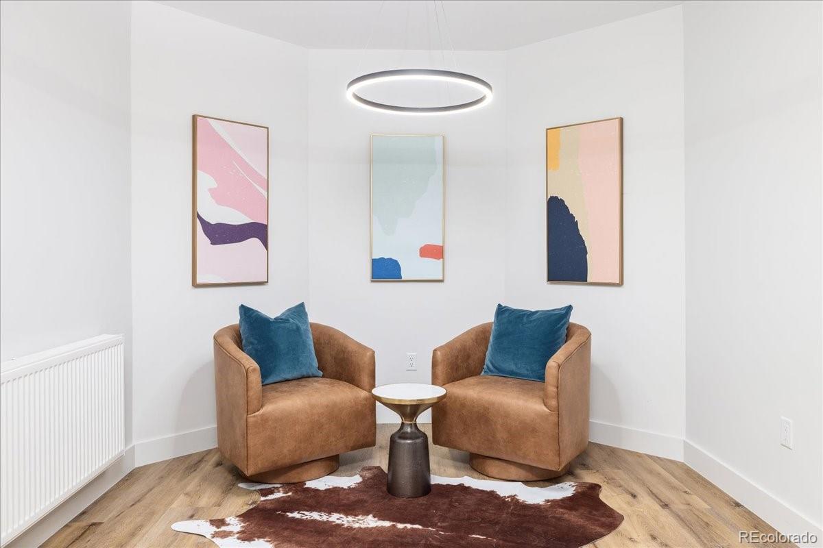 Sitting area with leather armchairs and abstract art