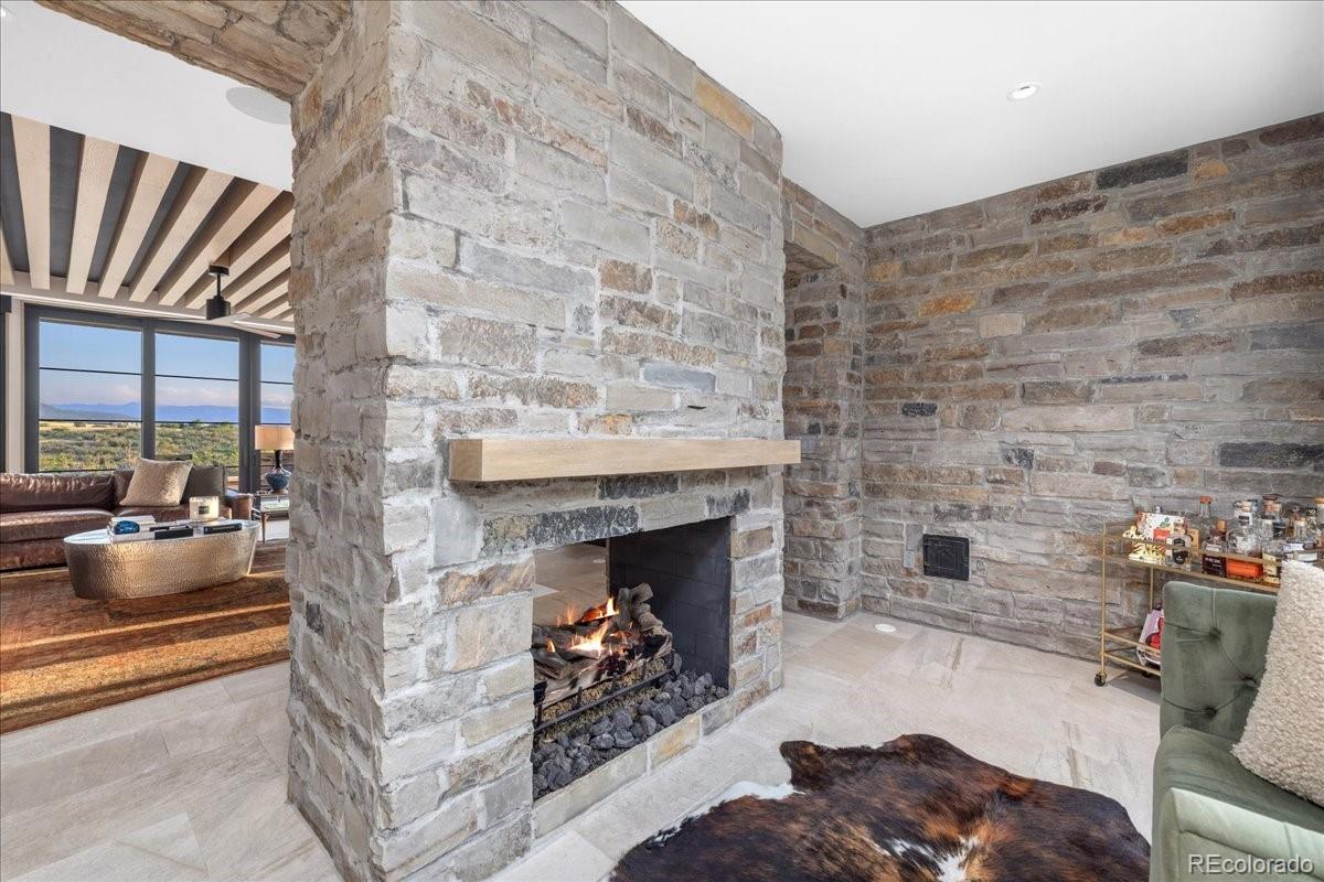 Stone fireplace and wood beam ceiling in great room