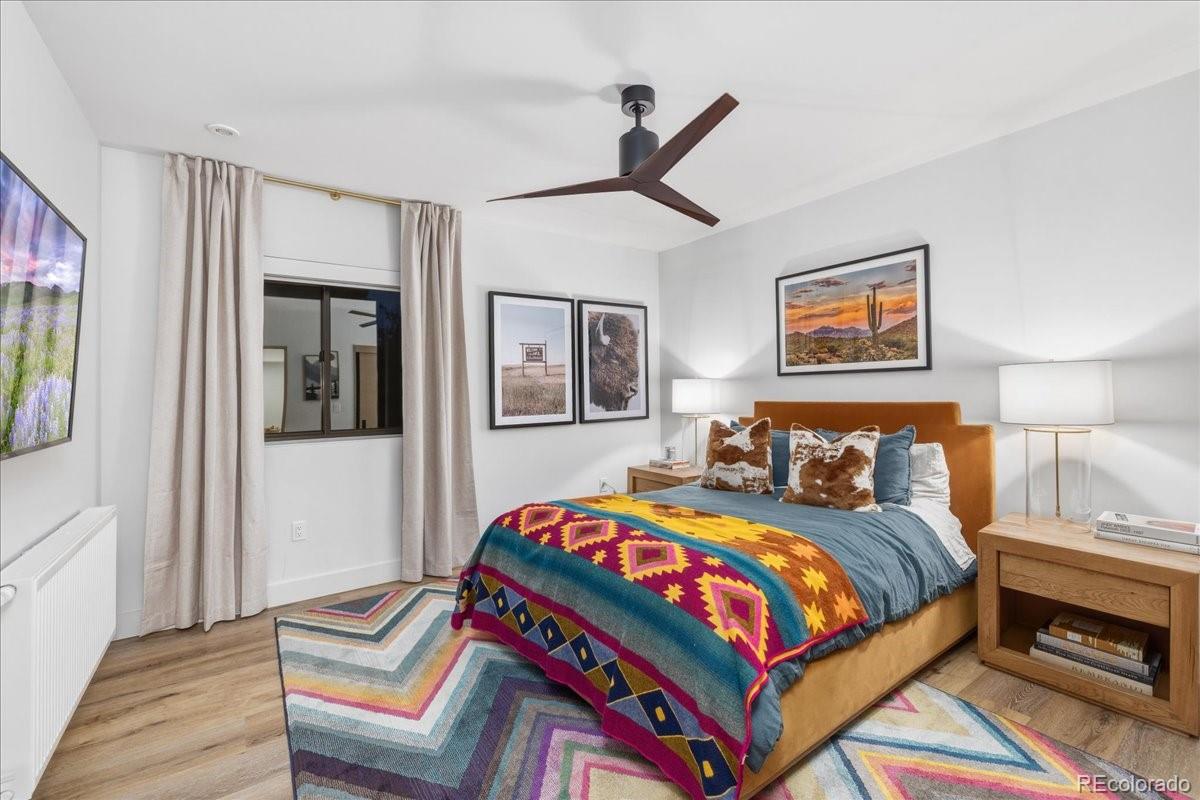  Guest bedroom with patterned bedding and ceiling fan