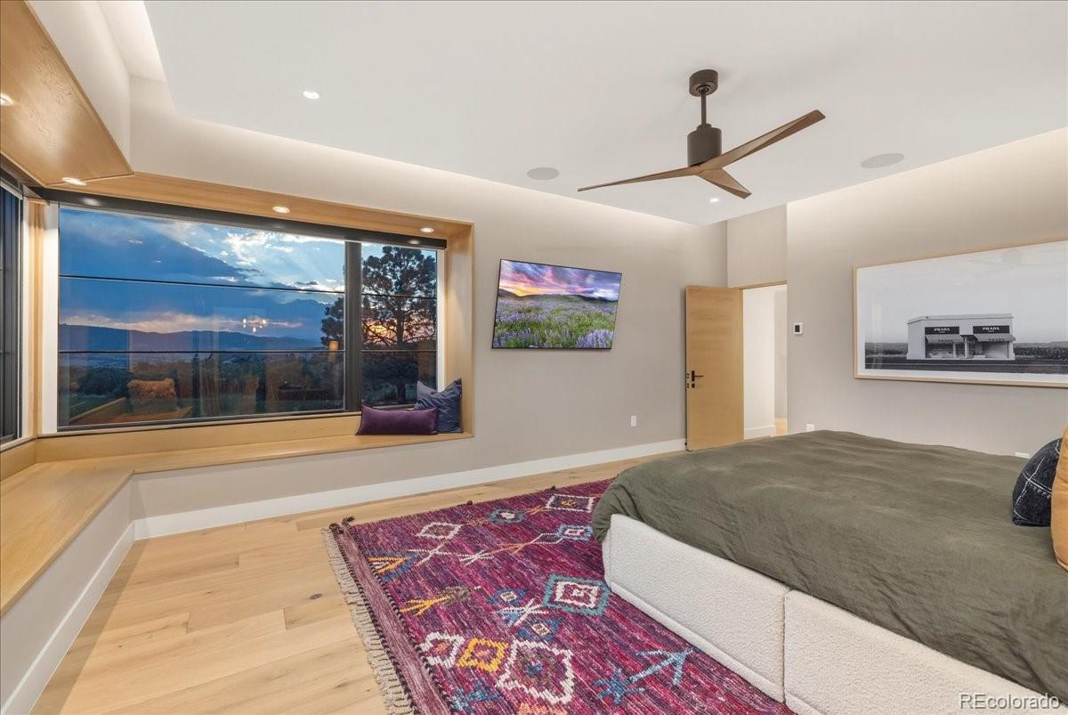Bedroom with mounted TV and mountain view window