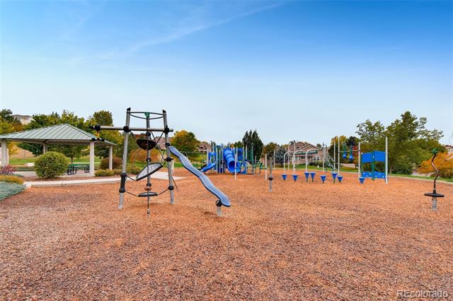 Playground with climbing structures, slides, swings, and a covered picnic shelter.