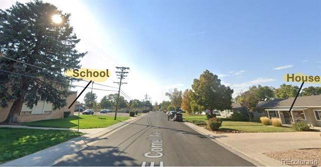 Residential street on E Cornell Avenue, with a school on the left and houses on the right.
