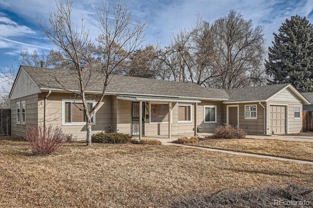 Single-story ranch house with a covered entry, attached garage, and leafless trees.