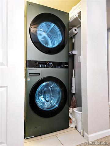 Stacked front-loading washer and dryer in a narrow laundry closet.