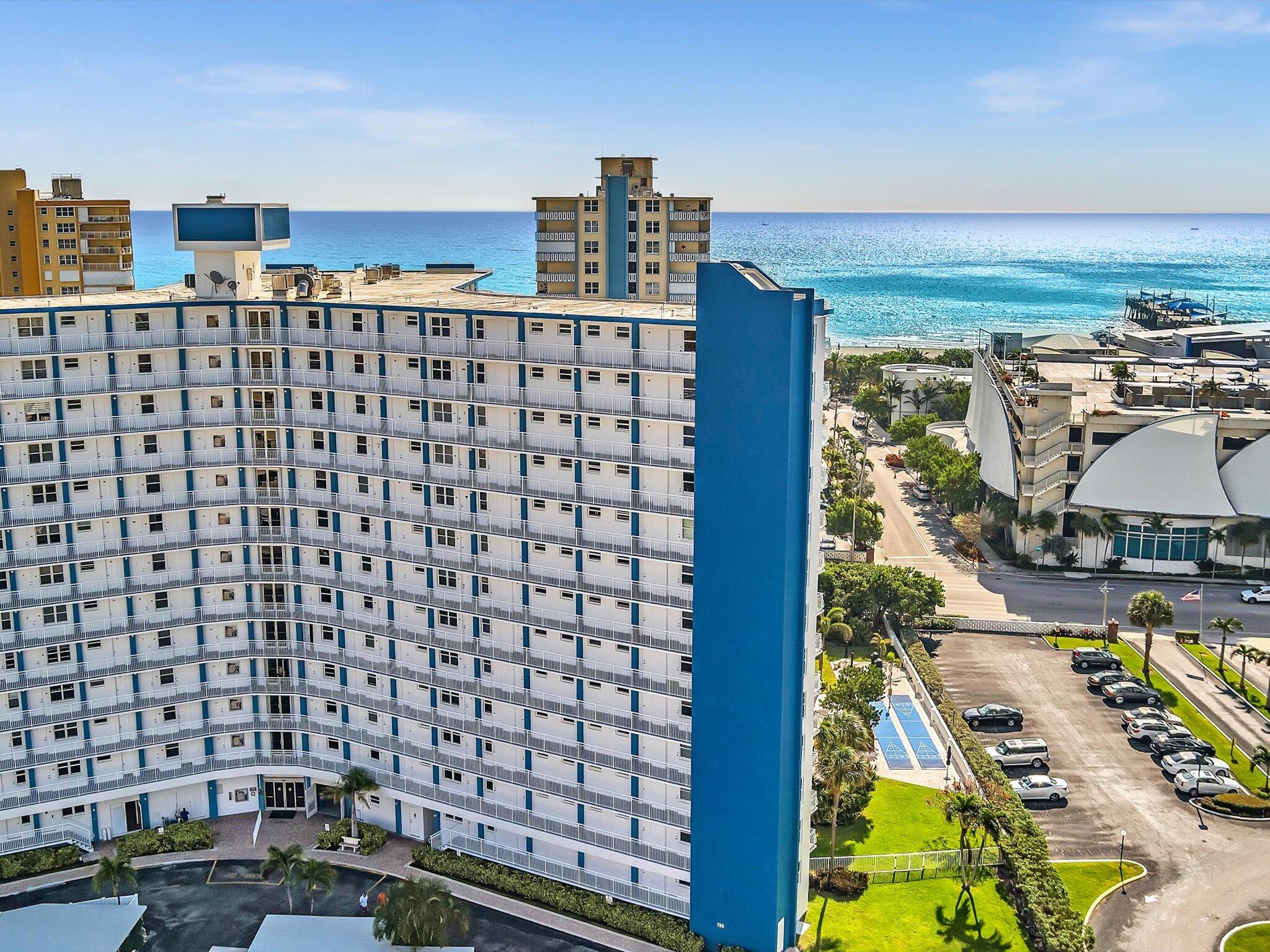 Oceanfront condominium with stacked balconies overlooking the Atlantic Ocean and beach.