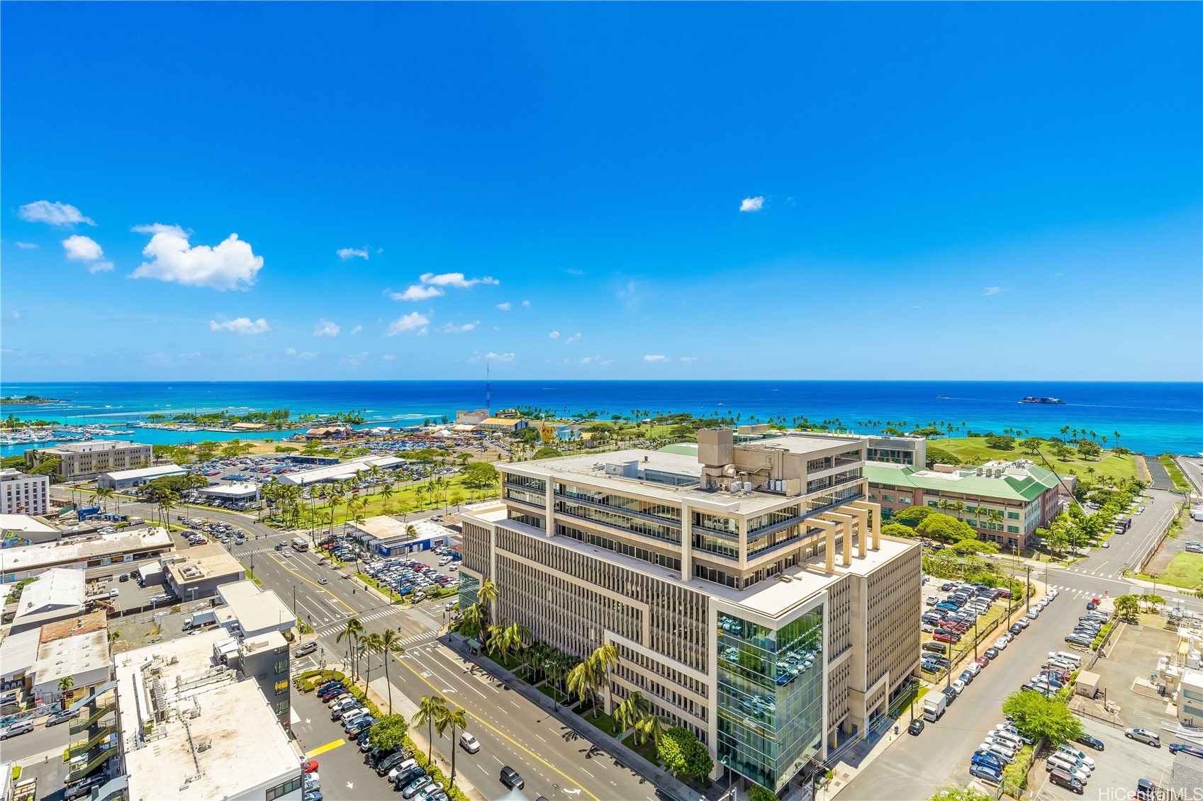 Honolulu ocean view beyond city buildings, with the harbor and palm-lined shoreline.