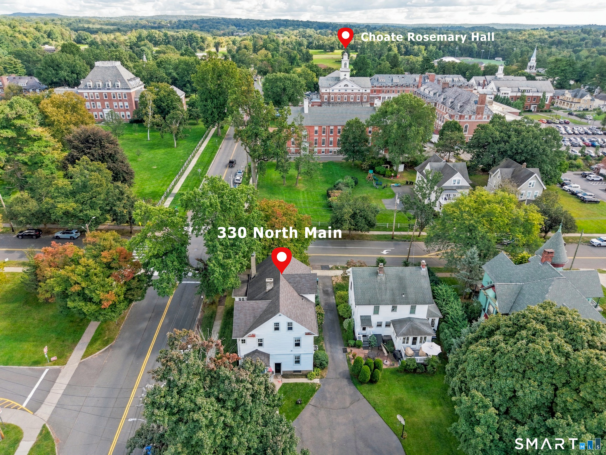 Aerial view of 330 North Main Street beside tree-lined roads, with Choate Rosemary Hall across the street.