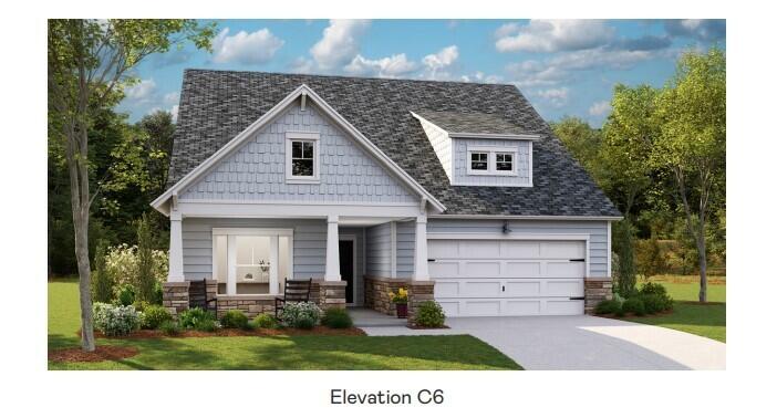 Light gray two-story house with a covered porch, stone accents, and attached two-car garage.