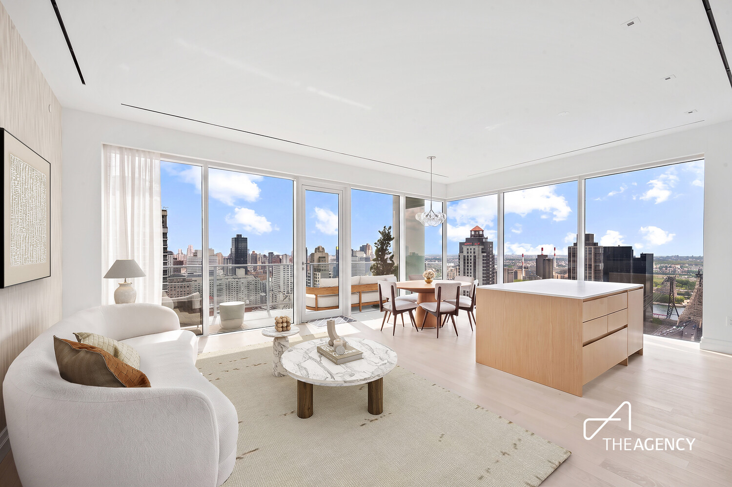 Staged living and dining area with a kitchen island and floor-to-ceiling city-view windows.