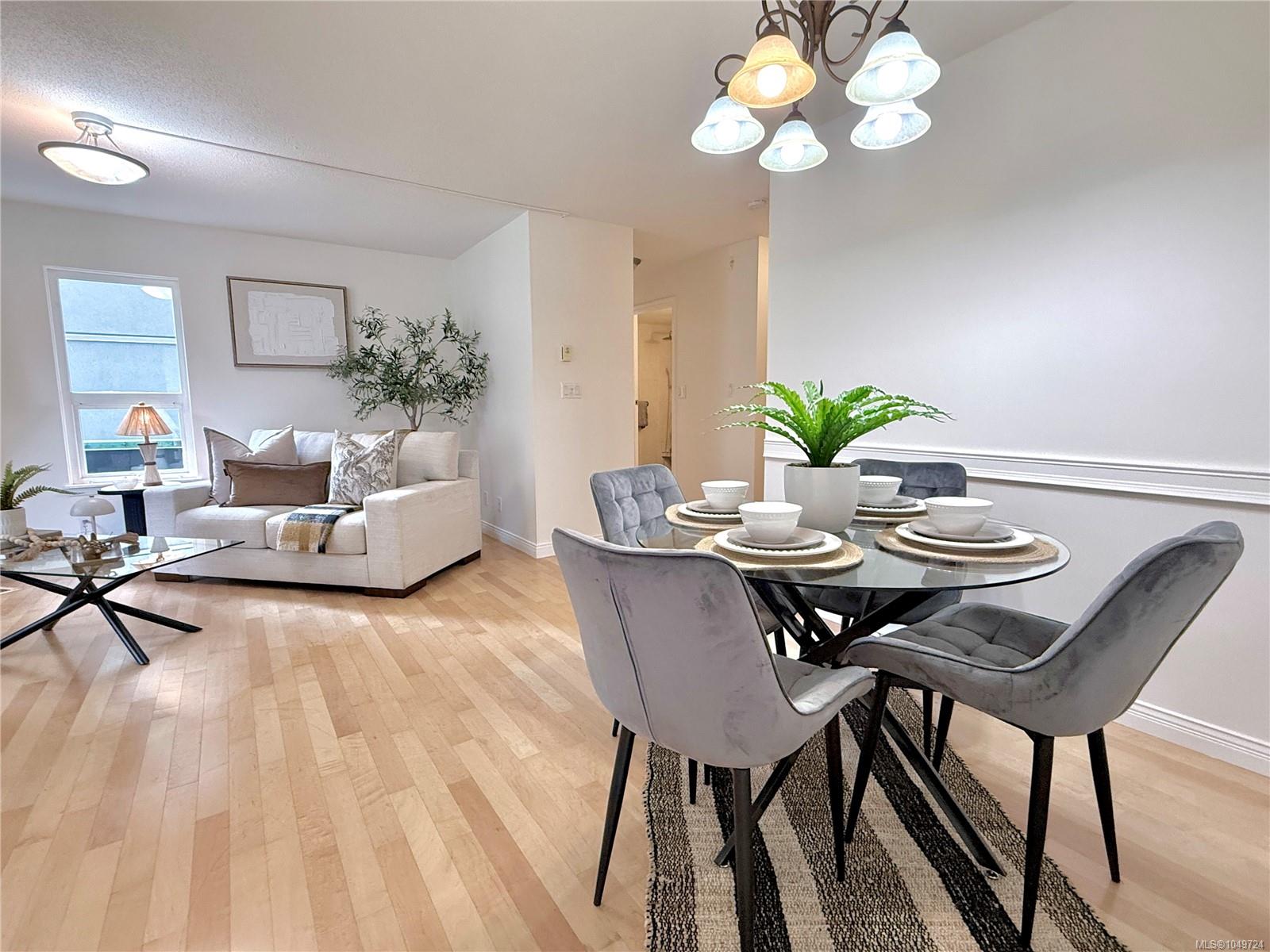 Open-plan living and dining area with a white sofa and round glass dining table.