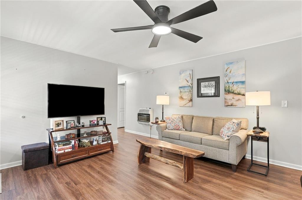 Living room with a beige sofa, wood coffee table, and television.