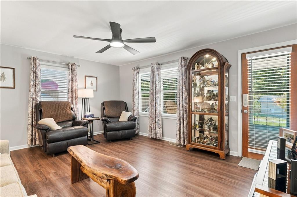 Living room with two leather recliners, a display cabinet, and a wood slab coffee table.