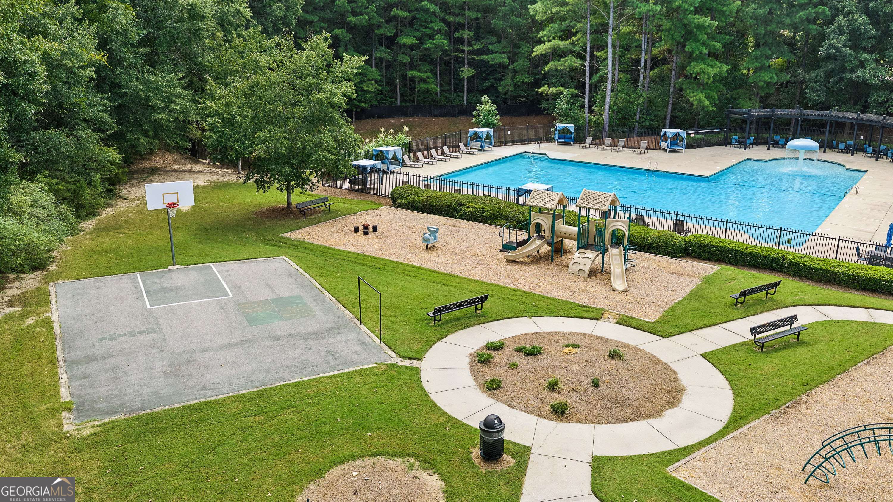 Community recreation area with a pool, playground, basketball court, and winding paths.