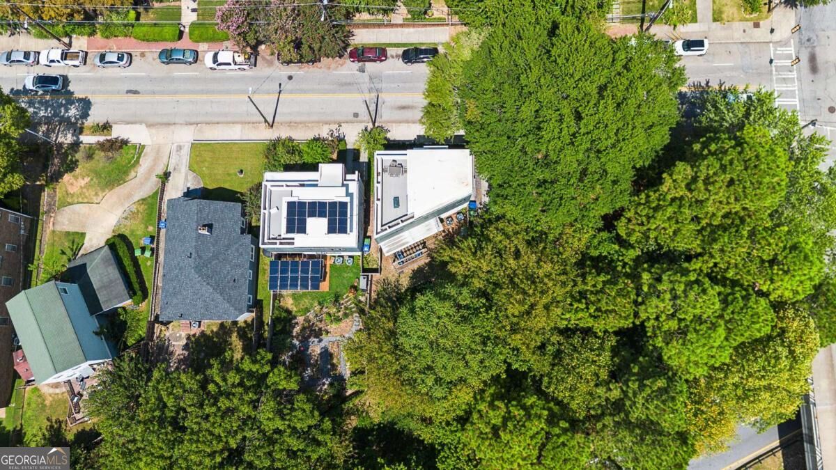 Aerial view of 575 Highland Avenue NE, with modern buildings, rooftop solar panels, and mature trees.